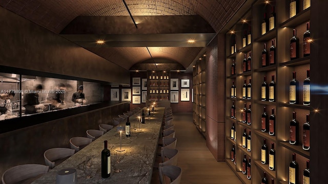 1210 Brickell Ave Unit 4804, Miami, FL 33131 - wine room featuring wood finished floors, wet bar, and lofted ceiling