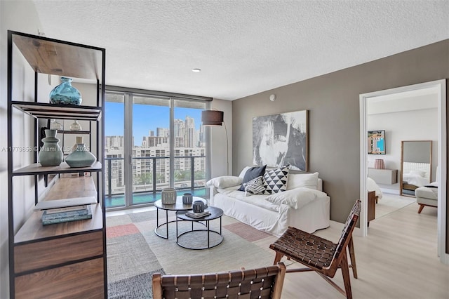 300 Sunny Isles Blvd Unit 4-903, Sunny Isles Beach, FL 33160 - living room featuring light wood-style floors, floor to ceiling windows, a textured ceiling, and a skyline view