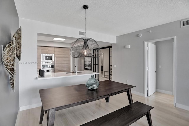 300 Sunny Isles Blvd Unit 4-903, Sunny Isles Beach, FL 33160 - dining room featuring light wood-type flooring and a textured ceiling