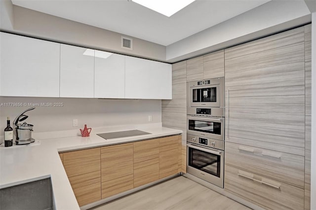 300 Sunny Isles Blvd Unit 4-903, Sunny Isles Beach, FL 33160 - kitchen featuring black electric cooktop, modern cabinets, and light countertops