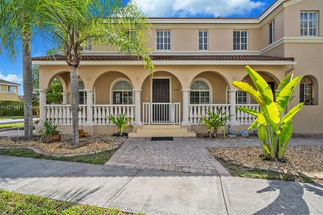 view of front of home featuring a porch and stucco siding