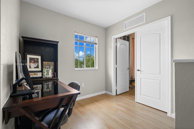 home office featuring visible vents, baseboards, and light wood-style floors