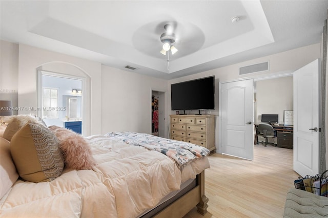 bedroom with visible vents and a tray ceiling
