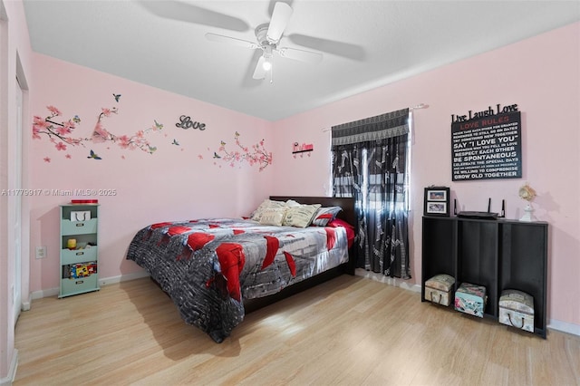 bedroom with baseboards, ceiling fan, and wood finished floors
