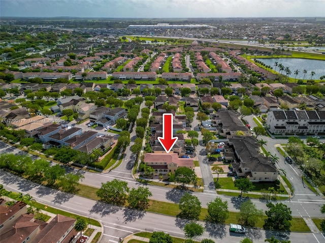 drone / aerial view featuring a water view and a residential view