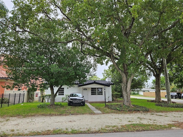 view of front of property featuring stucco siding and fence