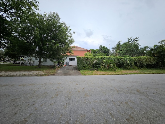 obstructed view of property featuring driveway
