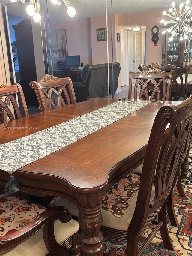 1865 S Ocean Dr Unit 3F, Hallandale Beach, FL 33009 - dining space with a chandelier and a textured ceiling