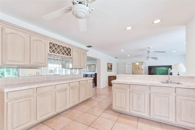 13925 SW 74th Ave, Palmetto Bay, FL 33158 - kitchen featuring ceiling fan, visible vents, cream cabinetry, light tile patterned flooring, and a sink