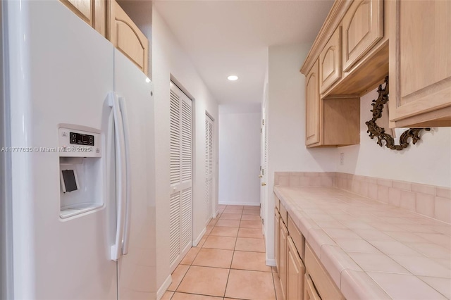 13925 SW 74th Ave, Palmetto Bay, FL 33158 - kitchen featuring light tile patterned floors, light brown cabinetry, tile counters, recessed lighting, and white refrigerator with ice dispenser