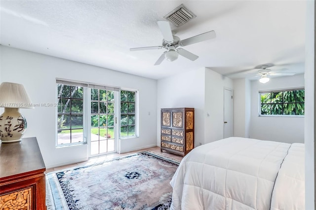 13925 SW 74th Ave, Palmetto Bay, FL 33158 - bedroom with visible vents, multiple windows, a textured ceiling, and ceiling fan