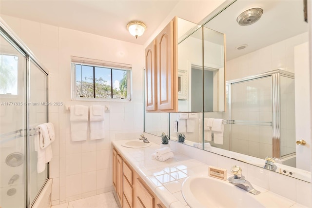 13925 SW 74th Ave, Palmetto Bay, FL 33158 - bathroom featuring a sink, tile walls, double vanity, and shower / bath combination with glass door