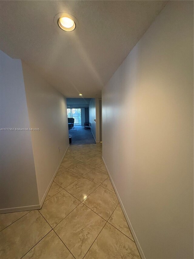 10133 NW 24th Pl Unit 206, Sunrise, FL 33322 - hallway with light tile patterned floors and baseboards