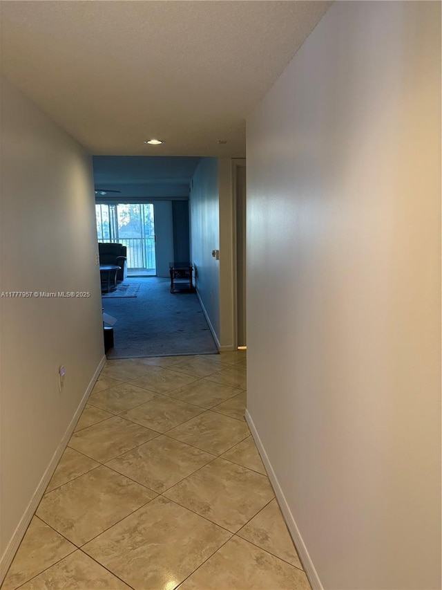 10133 NW 24th Pl Unit 206, Sunrise, FL 33322 - hallway featuring light tile patterned flooring and baseboards