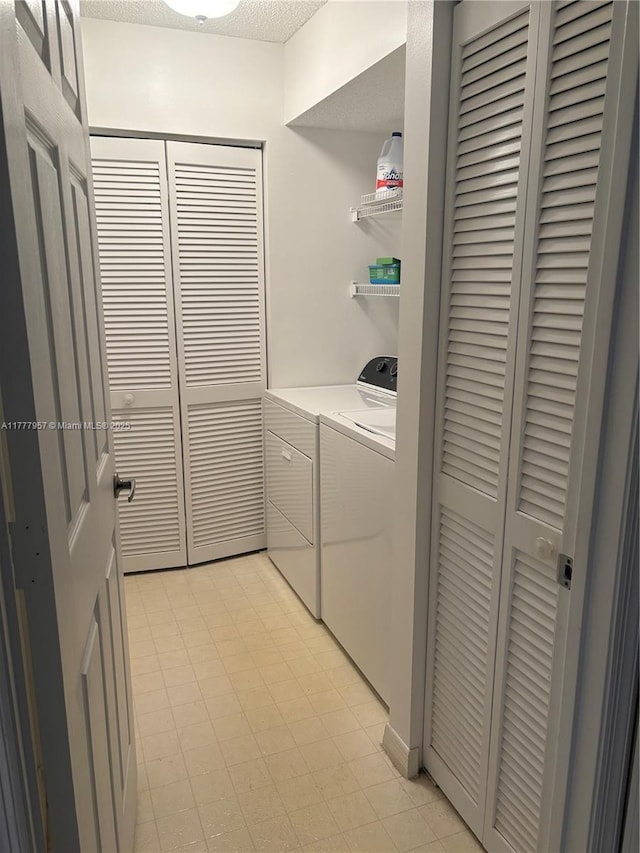 10133 NW 24th Pl Unit 206, Sunrise, FL 33322 - washroom featuring light floors, separate washer and dryer, laundry area, and a textured ceiling