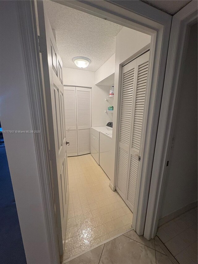 10133 NW 24th Pl Unit 206, Sunrise, FL 33322 - corridor featuring independent washer and dryer and a textured ceiling