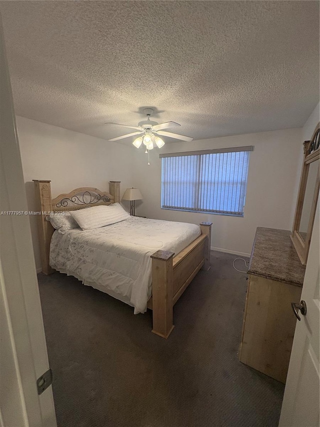 10133 NW 24th Pl Unit 206, Sunrise, FL 33322 - bedroom with dark carpet, ceiling fan, baseboards, and a textured ceiling