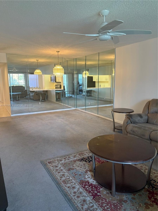 10133 NW 24th Pl Unit 206, Sunrise, FL 33322 - living room featuring a textured ceiling, ceiling fan, and carpet