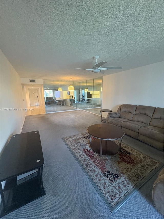 10133 NW 24th Pl Unit 206, Sunrise, FL 33322 - carpeted living room with a textured ceiling, ceiling fan, and visible vents
