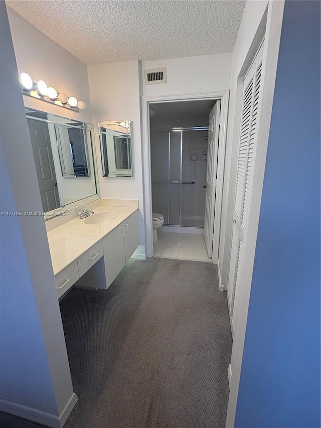 10133 NW 24th Pl Unit 206, Sunrise, FL 33322 - bathroom with a shower stall, a textured ceiling, visible vents, and toilet