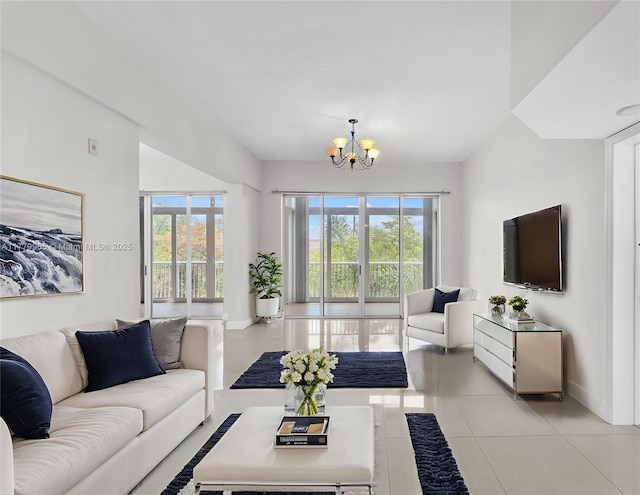 619 E Sheridan St Unit 406, Dania Beach, FL 33004 - living room featuring a chandelier, healthy amount of natural light, light tile patterned floors, and baseboards