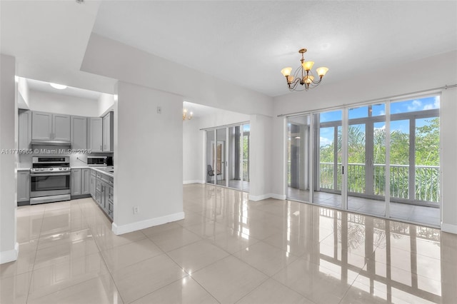 619 E Sheridan St Unit 406, Dania Beach, FL 33004 - kitchen with stainless steel range, gray cabinetry, a chandelier, and light tile patterned flooring
