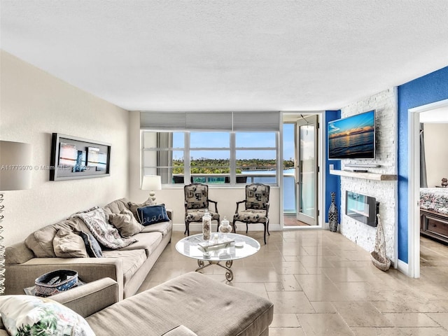 6770 Indian Creek Dr Unit 7K, Miami Beach, FL 33141 - living room featuring a stone fireplace and a textured ceiling