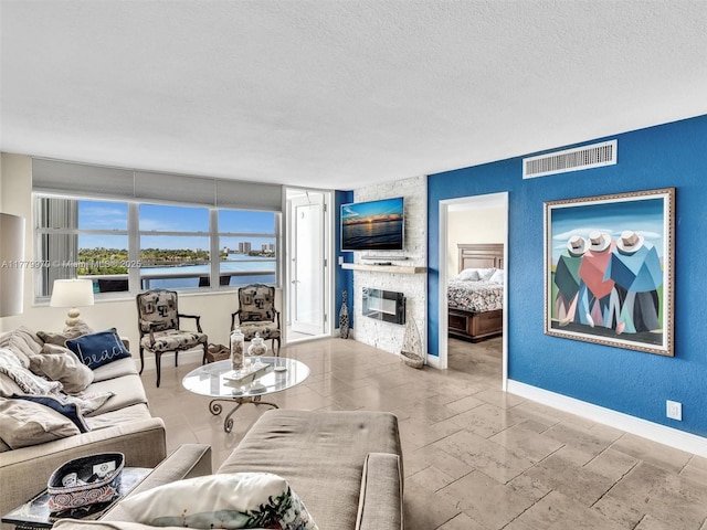 6770 Indian Creek Dr Unit 7K, Miami Beach, FL 33141 - living room featuring a textured ceiling and a fireplace