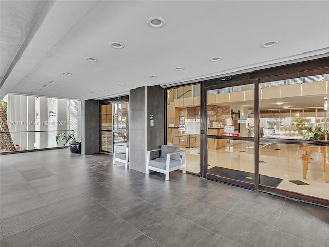 6770 Indian Creek Dr Unit 7K, Miami Beach, FL 33141 - community lobby featuring a wall of windows and recessed lighting