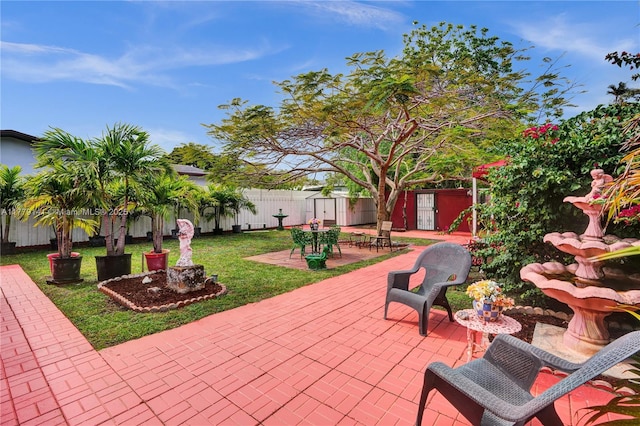 view of patio / terrace featuring a storage shed, an outbuilding, and a fenced backyard