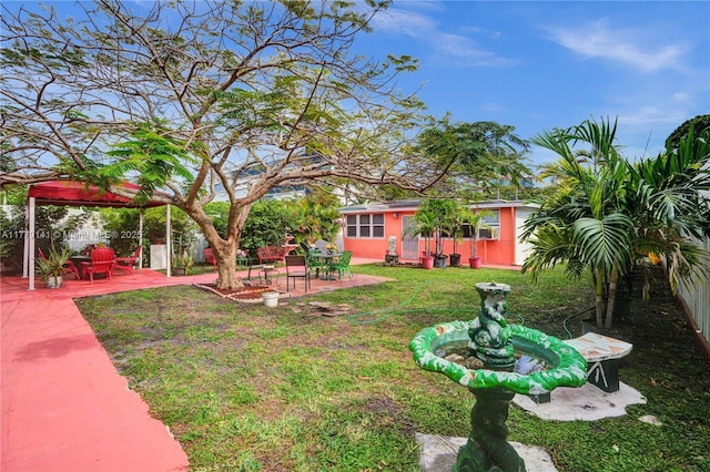 view of yard featuring a patio, fence, and a gazebo