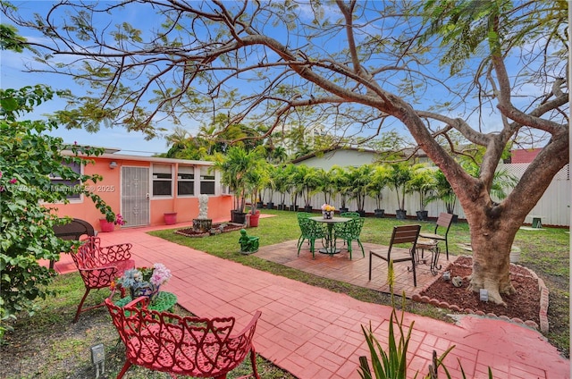 exterior space with outdoor dining area and fence