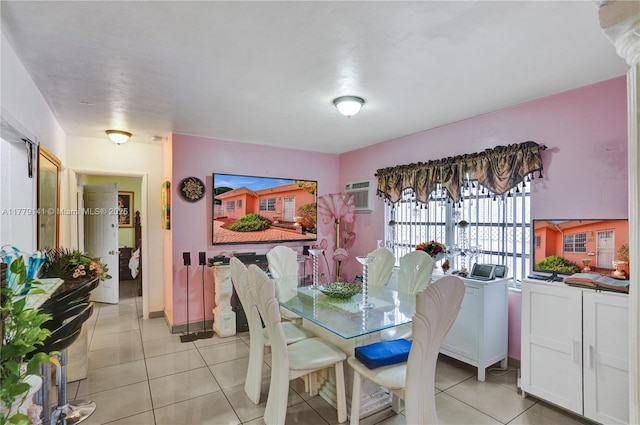 dining area featuring light tile patterned floors and a wall mounted air conditioner