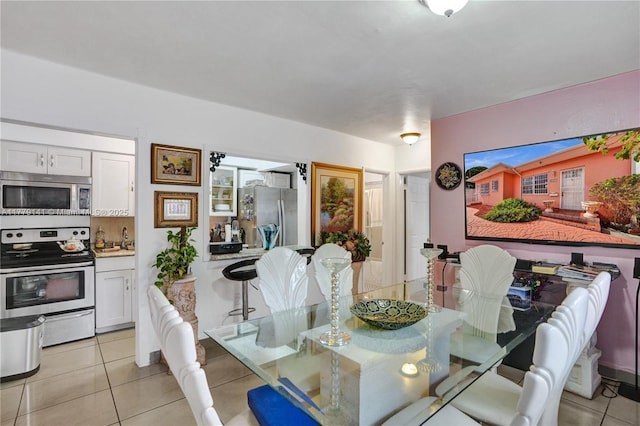 dining area featuring light tile patterned flooring