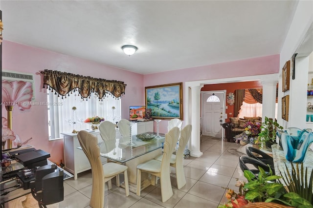 dining area with light tile patterned floors, decorative columns, and a wealth of natural light