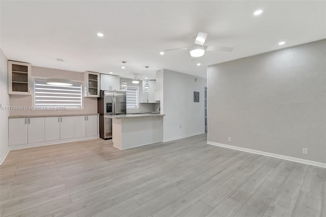 15600 NE 6th Ave Unit 30A, Miami, FL 33162 - kitchen with stainless steel fridge with ice dispenser, open floor plan, glass insert cabinets, and light wood finished floors