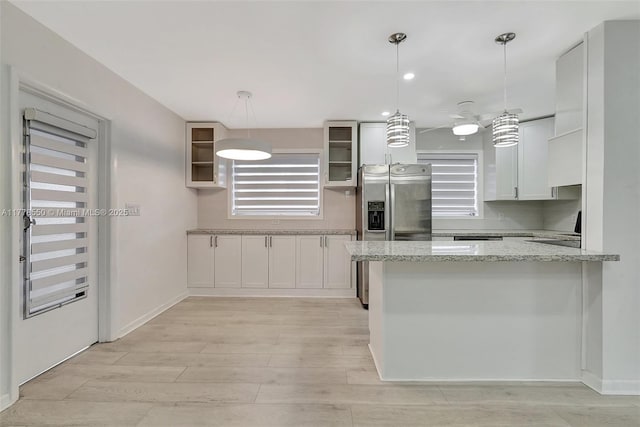 15600 NE 6th Ave Unit 30A, Miami, FL 33162 - kitchen with a wealth of natural light, light wood-type flooring, stainless steel fridge, and a peninsula