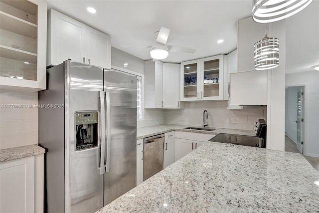 15600 NE 6th Ave Unit 30A, Miami, FL 33162 - kitchen with appliances with stainless steel finishes, glass insert cabinets, white cabinets, decorative backsplash, and a sink