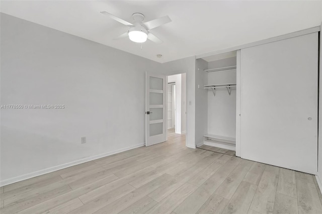 15600 NE 6th Ave Unit 30A, Miami, FL 33162 - unfurnished bedroom with light wood-style flooring, a closet, baseboards, and a ceiling fan