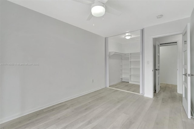 15600 NE 6th Ave Unit 30A, Miami, FL 33162 - unfurnished bedroom with a closet, baseboards, ceiling fan, a walk in closet, and light wood finished floors