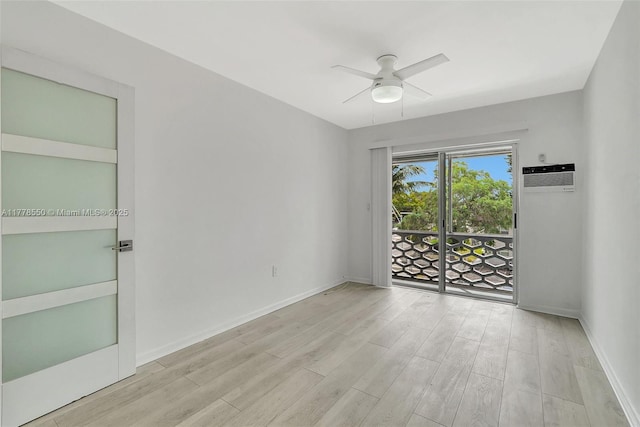 15600 NE 6th Ave Unit 30A, Miami, FL 33162 - spare room featuring wood finished floors, ceiling fan, baseboards, and an AC wall unit