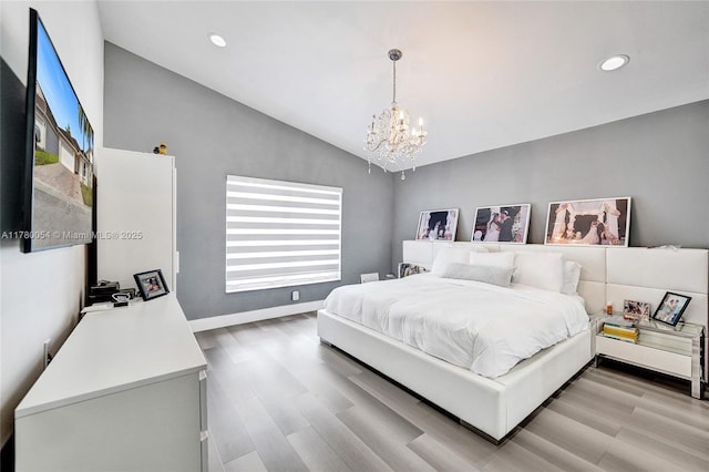 bedroom featuring baseboards, a notable chandelier, light wood finished floors, recessed lighting, and lofted ceiling