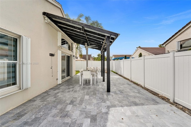 view of patio featuring a fenced backyard and outdoor dining area