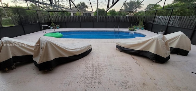 view of pool featuring fence, a lanai, and a fenced in pool
