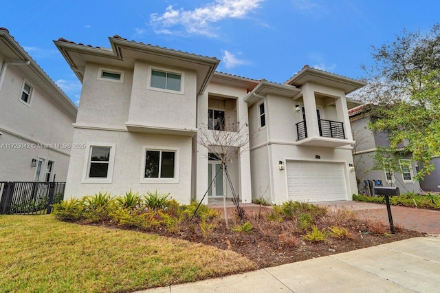 3527 Forest View Cir, Dania Beach, FL 33312 - view of front of house featuring a balcony, driveway, an attached garage, fence, and stucco siding