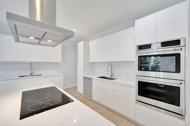 3527 Forest View Cir, Dania Beach, FL 33312 - kitchen featuring modern cabinets, island exhaust hood, a sink, and appliances with stainless steel finishes
