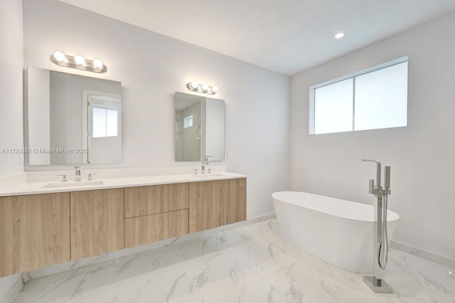 3527 Forest View Cir, Dania Beach, FL 33312 - full bath featuring a freestanding bath, double vanity, marble finish floor, and a sink