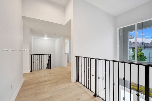 3527 Forest View Cir, Dania Beach, FL 33312 - corridor with wood finished floors, baseboards, and an upstairs landing