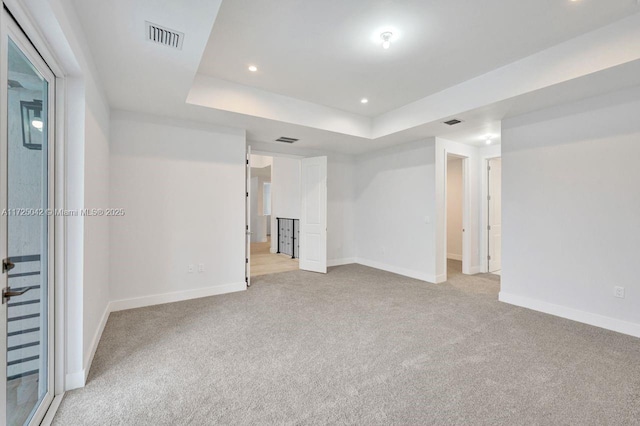3527 Forest View Cir, Dania Beach, FL 33312 - unfurnished room featuring light carpet, a tray ceiling, visible vents, and baseboards