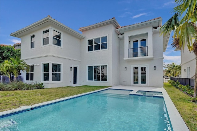 3527 Forest View Cir, Dania Beach, FL 33312 - back of house featuring a yard, french doors, a balcony, and fence